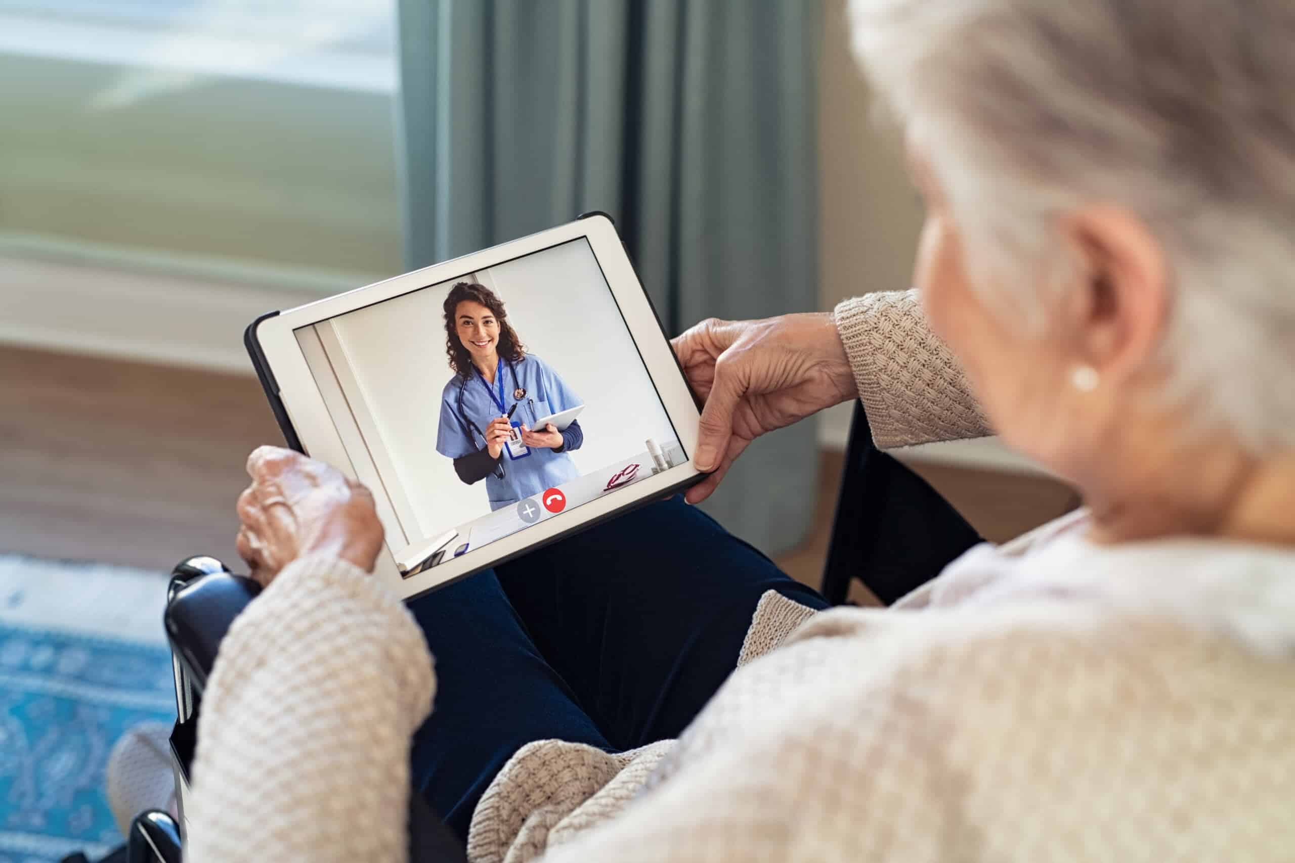 Woman talking with her medical provider via telehealth and a tablet